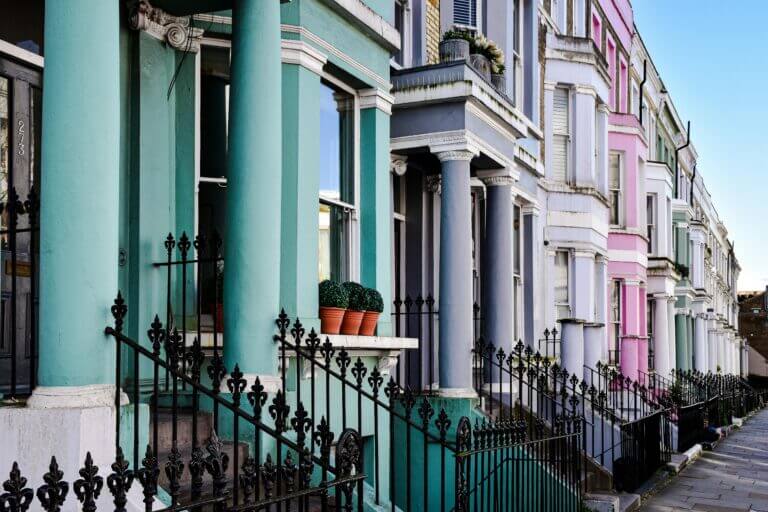 Vibrant row of colorful houses in Notting Hill, London.
