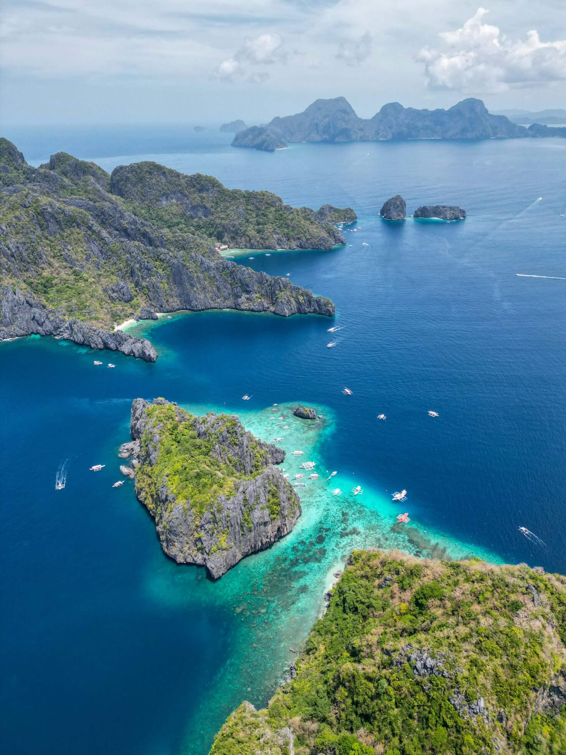 A breathtaking drone shot capturing the lush islands surrounded by crystal blue waters in Palawan, Philippines