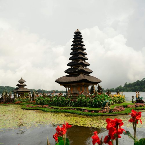 Pura Ulun Danu Beratan on tranquil Lake Bratan amidst scenic flora in Bali, Indonesia.