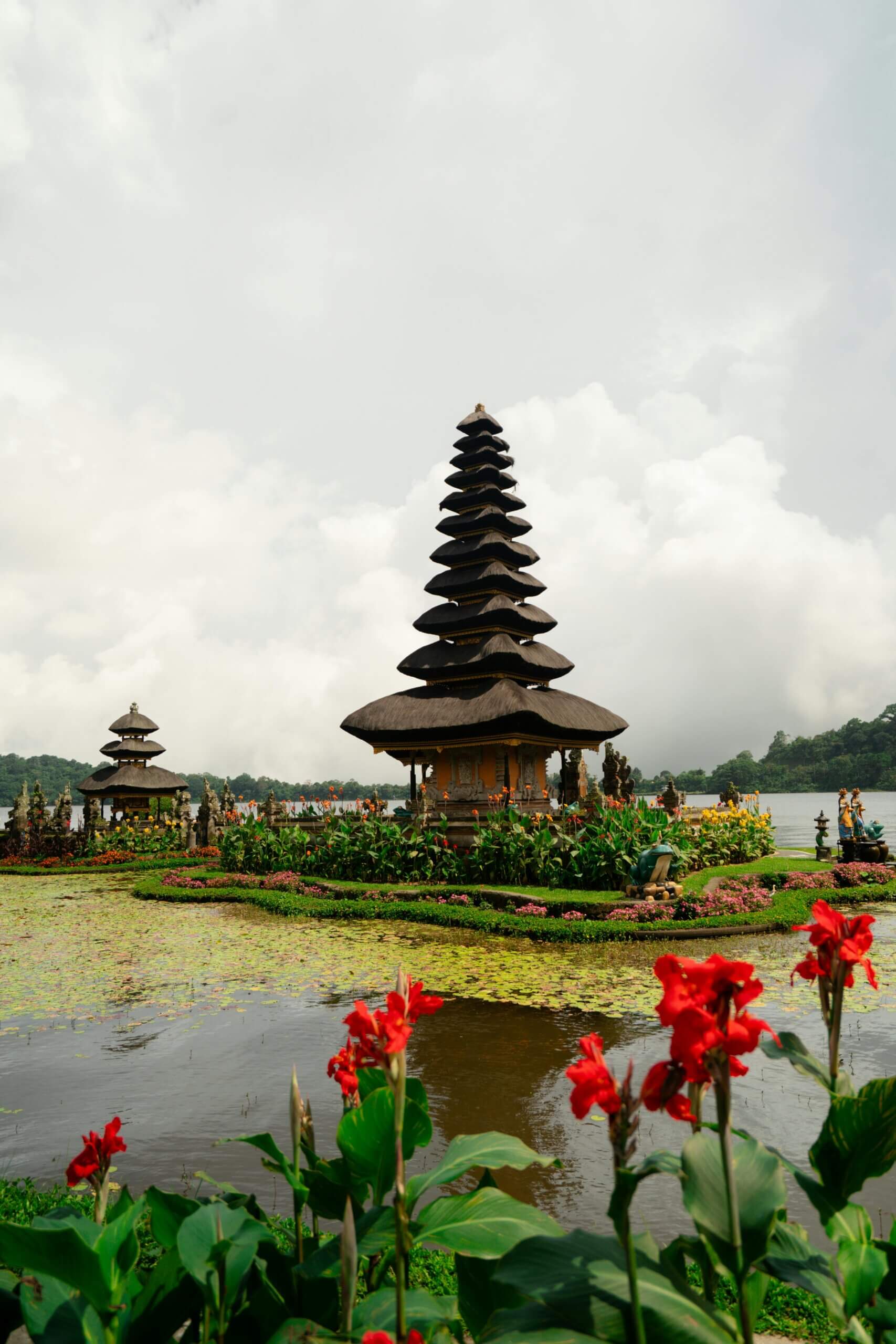 Pura Ulun Danu Beratan on tranquil Lake Bratan amidst scenic flora in Bali, Indonesia.